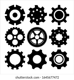 Silhouettes of gearwheels and screw-wheels. Abstract collection of metal round details for rotate and motion. Vector set of gears and cogs.