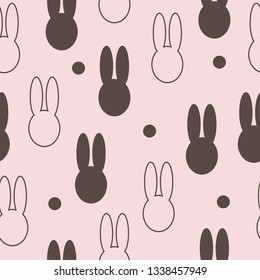 Silhouettes of a head of a rabbit on a pale pink background