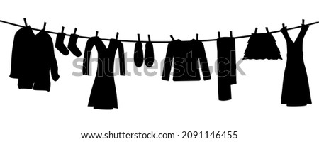 Silhouettes of laundry on rope isolated on white background. Various clothes hanging on clothesline. Clean apparel drying on line. Washingline with dresses monochrome icon. Stock vector illustration