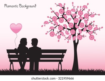 Silhouettes loving couple sitting on a bench next to a cherry tree with flowers.