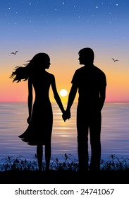 Silhouettes of man and woman standing and holding hands at evening time.  On the background sunset and stars over the sea.