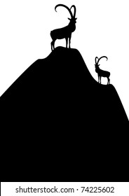 Silhouettes of mountain goats standing on top of the mountain.