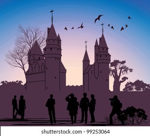 silhouettes of people against the backdrop of an ancient castle