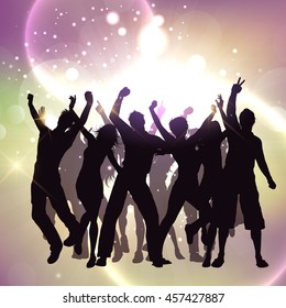 Silhouettes of people dancing on a bokeh lights background