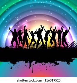 Silhouettes of people dancing on a rainbow background