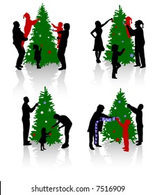 Silhouettes of the people decorating a Christmas tree.