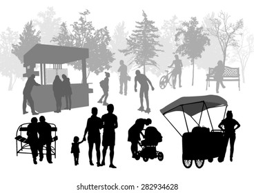 Silhouettes of people in urban park