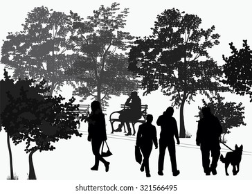 silhouettes of people walking in the park among the trees