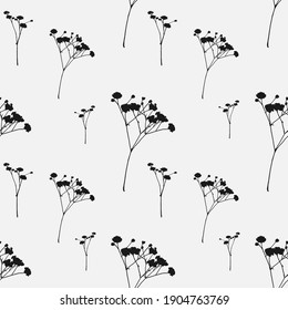 Silhouettes of small black flowers on a white background in a seamless pattern

