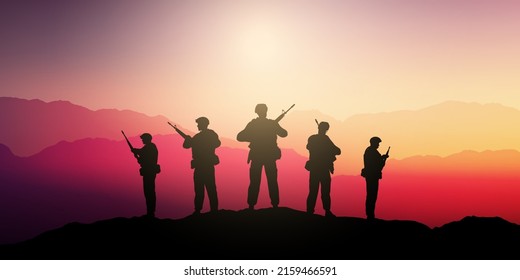 Silhouettes of soldiers standing guard in a sunset landscape 