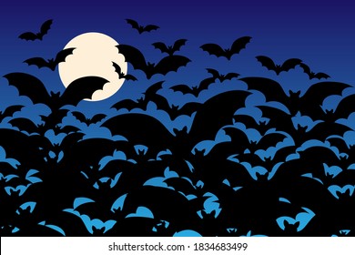 Silhouettes of spooky Halloween bats swarming in front of a full moon blue night sky