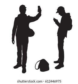 
Silhouettes of a teenager taking pictures of himself on a smart phone sending a message, black color, isolated on a white background