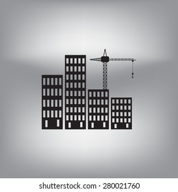 Silhouettes of three cranes working on the building