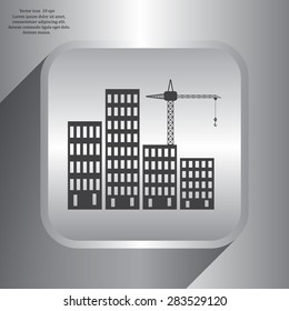Silhouettes of three cranes working on the building