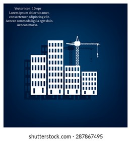 Silhouettes of three cranes working on the building