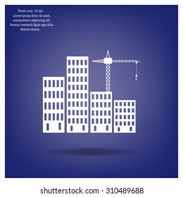 Silhouettes of three cranes working on the building