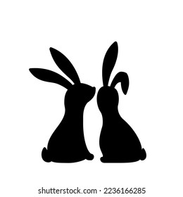 Silhouettes of two bunnies in love. Easter bunnies are seating together.