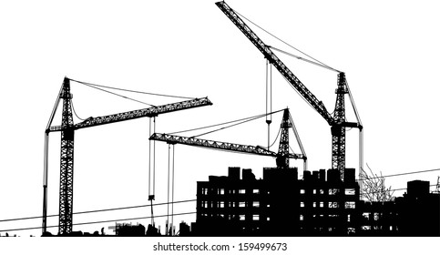 Silhouettes of two cranes near of building
