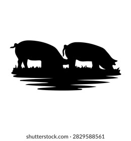 Silhouettes of two hippos standing in water, drinking at sunset, capturing wildlife in their natural habitat with a serene and peaceful atmosphere.