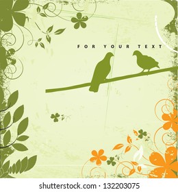Silhouettes of two pigeons sitting on the grunge branch of cherry blossom and kissing