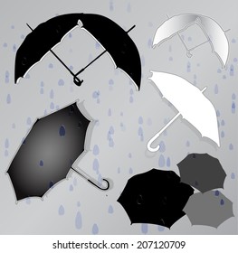 Silhouettes of umbrellas in the background of raindrops