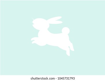 Silhouettes of white easter rabbit jupms over in the light blue background 