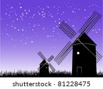 Silhouettes of windmills on starry sky