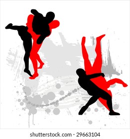 Silhouettes of wrestlers on abstract background.