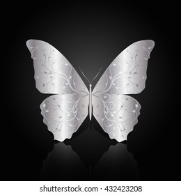 Silver abstract butterfly with floral pattern on black background with reflection.