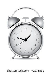 Silver alarm clock over white background
