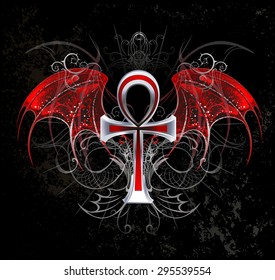 Silver ankh  with red wings on black background.