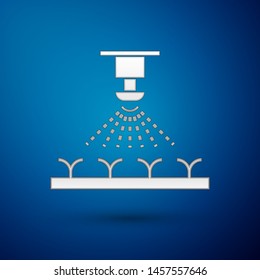 Silver Automatic irrigation sprinklers icon isolated on blue background. Watering equipment. Garden element. Spray gun icon.  Vector Illustration