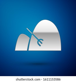 Silver Bale of hay and rake icon isolated on blue background.  Vector Illustration