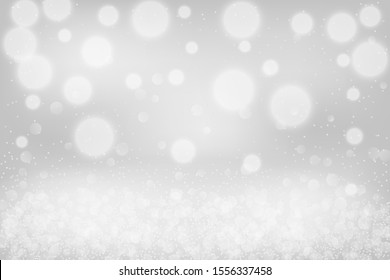 Silver bokeh background. Christmas glowing lights with sparkles. Holiday decorative effect.