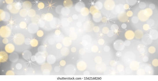 Silver bokeh background. Christmas glowing silver and golden lights with sparkles. Holiday decorative effect.