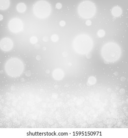 Silver bokeh background. Christmas glowing lights with sparkles. Holiday decorative effect.