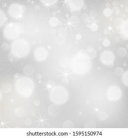 Silver bokeh background. Christmas glowing lights with sparkles. Holiday decorative effect.