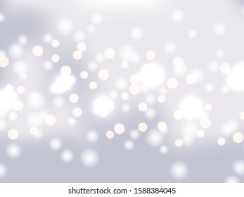 Silver bokeh background. Holiday glowing silver lights with sparkles. Festive defocused lights. Blurred bright abstract bokeh on light background.