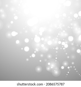 Silver Bokeh Christmas Background. Snow Flakes on Light Grey. Blurred Vector Design. Holiday Winter Backdrop With Glow and Overlay Effect. Season Bling Christmas Decoration.