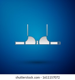 Silver Bra icon isolated on blue background. Woman underwear.  Vector Illustration