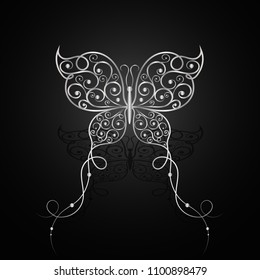 Silver butterfly with swirl pattern on dark background.