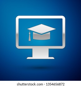 Silver Computer monitor with graduation cap icon isolated on blue background. Online learning or e-learning concept. Internet knowledge symbol. Vector Illustration