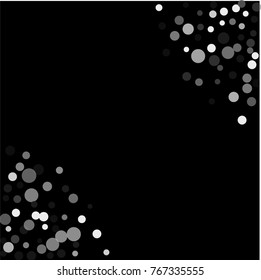 Silver confetti on a black background. Luxury festive background. Silver translucent abstract dots are scattered on a black background.