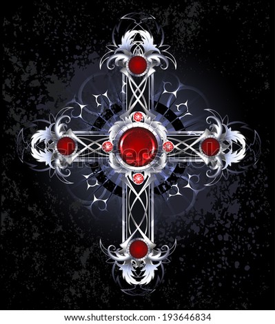 Silver cross of interwoven leaves, decorated with round rubies on black background.