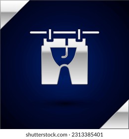Silver Drying clothes icon isolated on dark blue background. Clean shirt. Wash clothes on a rope with clothespins. Clothing care and tidiness.  Vector