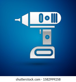 Silver Electric cordless screwdriver icon isolated on blue background. Electric drill machine. Repair tool.  Vector Illustration