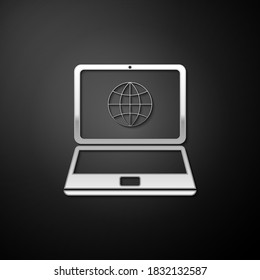 Silver Globe on screen of laptop icon isolated on black background. Notebook computer with globe sign. Long shadow style. Vector.