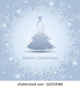 Silver and glossy Christmas tree placed on frosty winter background