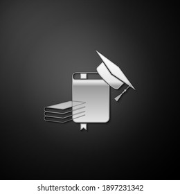 Silver Graduation cap and book icon isolated on black background. Long shadow style. Vector.