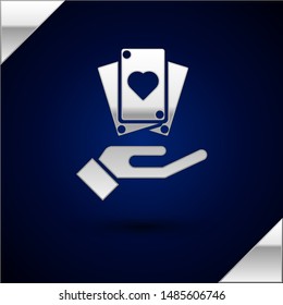 Silver Hand holding playing cards icon isolated on dark blue background. Сasino game design.  Vector Illustration